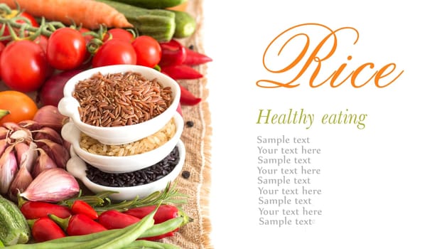 Red, black and unpolished organic rice in bowls and vegetables