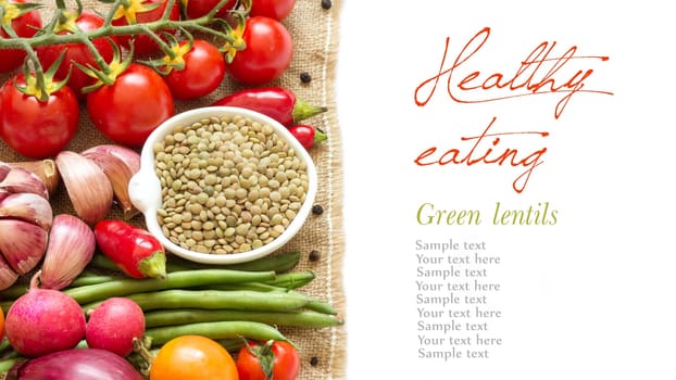 Green lentils in bowl and vegetables isolated on white