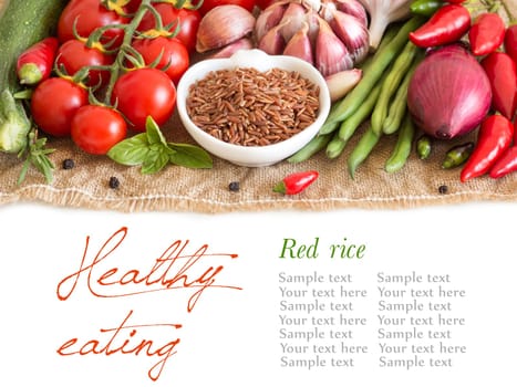 Red organic rice in bowl and vegetables
