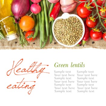 Green lentils in bowl and vegetables isolated on white