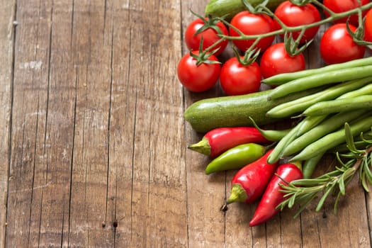 Red and green vegetables on a wooden table