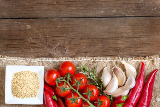 Millet, vegetables and herbs on wooden table
