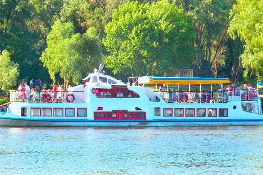 landscape with promenade motor ship with passengers on Desna river near Chernihiv