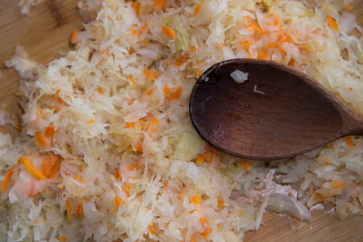 close up on sauerkraut on wooden plate