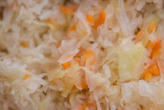 close up on sauerkraut on wooden plate,selective focus