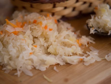 close up on sauerkraut on wooden plate