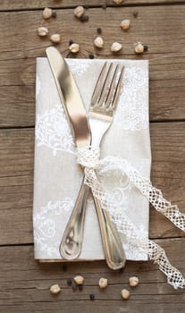 Rustic Table setting with vintage lace ribbon on old wooden table