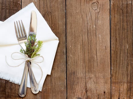 Rustic Table setting with juniper decor on old wooden table