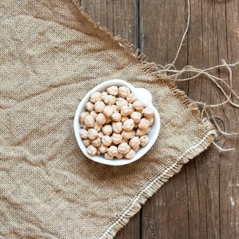 Raw Organic chickpea in a bowl on wooden table