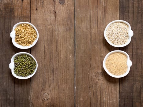 Raw Organic Amaranth and quinoa grains, wheat and mung beans in small bowls