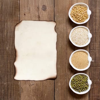Raw Organic Amaranth and quinoa grains, wheat and mung beans in small bowls