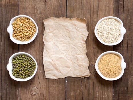 Raw Organic Amaranth and quinoa grains, wheat and mung beans in small bowls