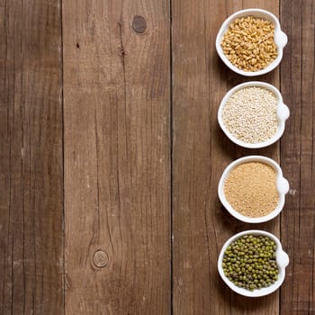 Raw Organic Amaranth and quinoa grains, wheat and mung beans in small bowls