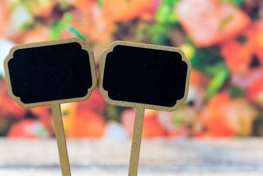 Wooden mini blackboard labels over vegetable salad background and table, copy space available