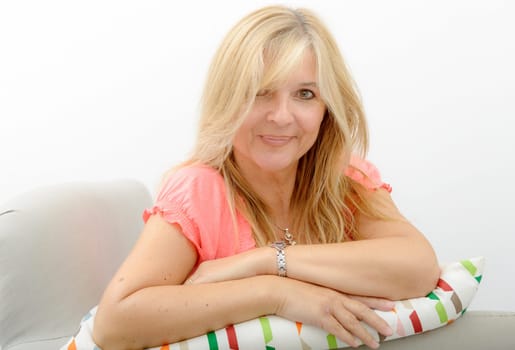 Portrait of blond mature woman relaxing in sofa