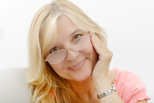 Portrait of blond mature woman relaxing in sofa