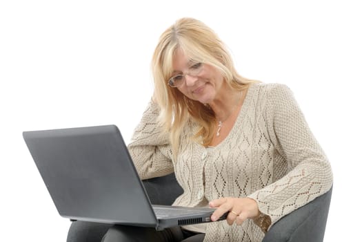 a portrait of a smiling mature woman using laptop