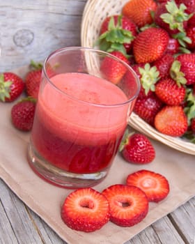 Fresh strawberry smoothie juice and strawberries