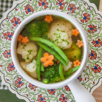 Rustic soup with fresh colorful vegetables