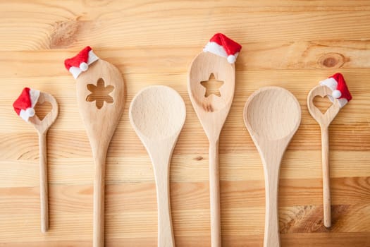 Rustic wooden loeffels with small St. Nicholas mucks on a rustic background