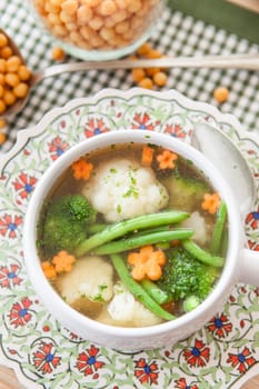 Rustic soup with fresh colorful vegetables