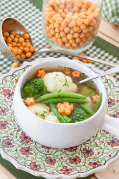 Rustic soup with fresh colorful vegetables