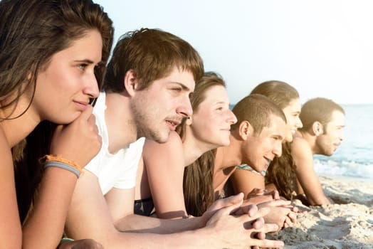 Group of happy teenage friends at the beach