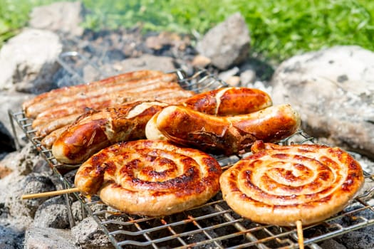 Grilling bratwursts on a charcoal grill