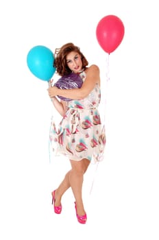 A gorgeous young woman standing in a dress with balloons attached.lifting her dress, isolated for white background..