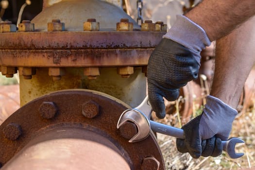 Workman at work in an old plumbing with equipment.