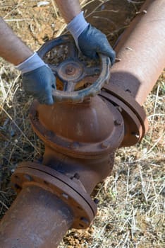 Workman at work in an old plumbing with equipment.
