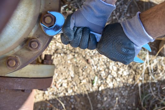 Workman at work in an old plumbing with equipment.