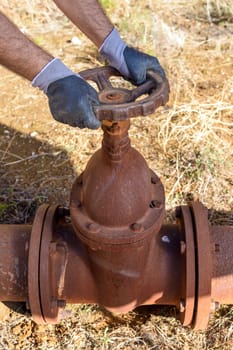 Workman at work in an old plumbing with equipment.