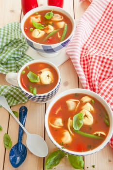 Rustic tomato soup with vegetables and tortellini
