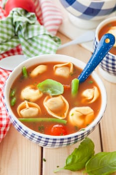Rustic tomato soup with vegetables and tortellini