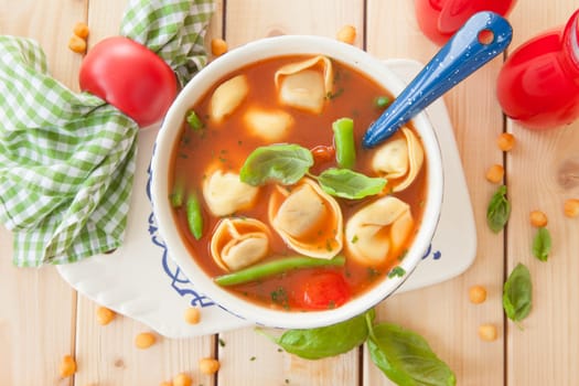 Rustic tomato soup with vegetables and tortellini