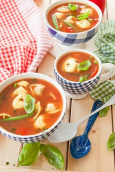 Rustic tomato soup with vegetables and tortellini