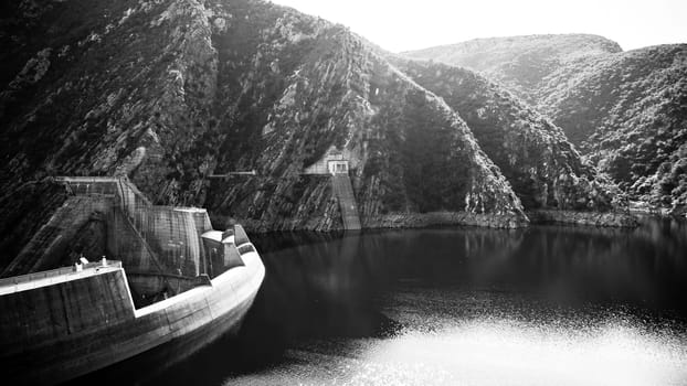 The Kouga Dam is an arch dam on the Kouga River about 21 km west of Patensie in Kouga Local Municipality, South Africa.