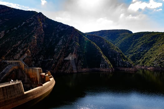 The Kouga Dam is an arch dam on the Kouga River about 21 km west of Patensie in Kouga Local Municipality, South Africa.