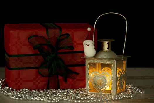 Christmas gifts and a lantern with a candle
