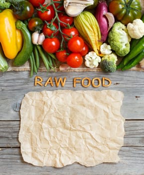 Fresh vegetables and wooden letters on an old wooden table