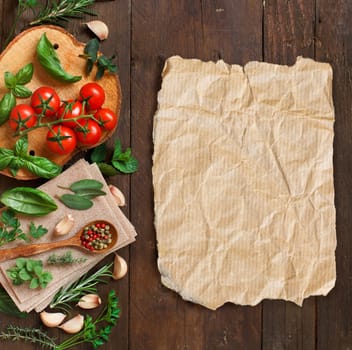 Raw lasagna pasta, vegetables and herbs on a wooden background
