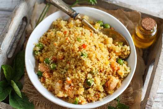 Couscous with shrimps and vegetables in a bowl