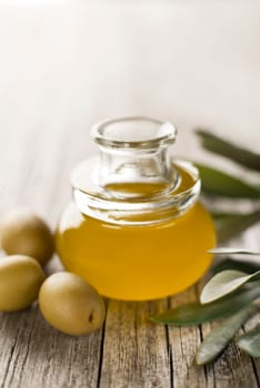 Olive oil in a bottle on a wooden table