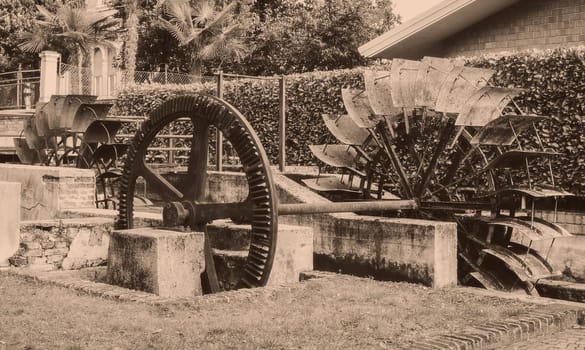 Old wheels of a watermill. Vintage style picture. Adding grain to give an old photo effect.