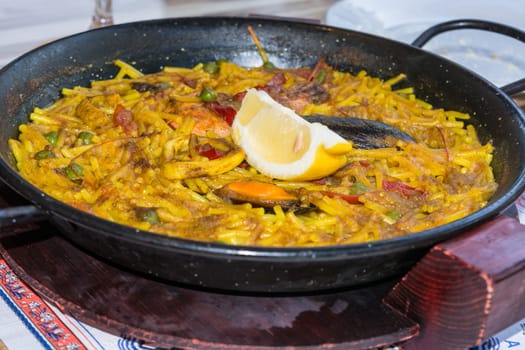 Valencia paella with seafood and fresh lobfish,squid and mussels..