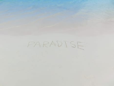 The inscription on and from the sand Paradise