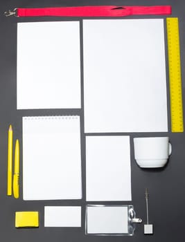 Mock-up business template with cards, papers, pen on gray background.