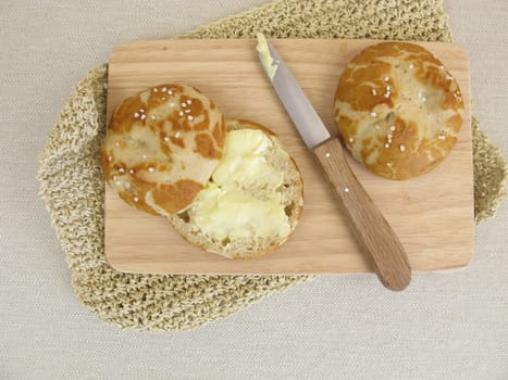 Sliced homemade pretzel rolls with butter