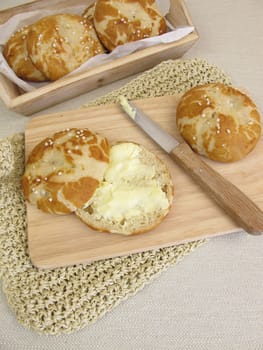 Sliced homemade pretzel rolls with butter